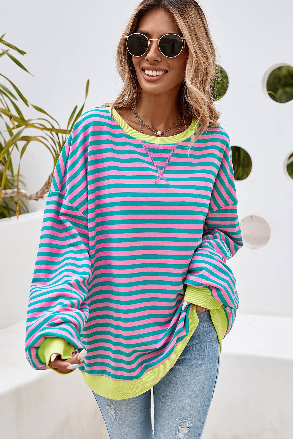 This colorful striped top is both stylish and comfortable. This top features a combination of blue, yellow, and green stripes, making it a vibrant and eye-catching piece.