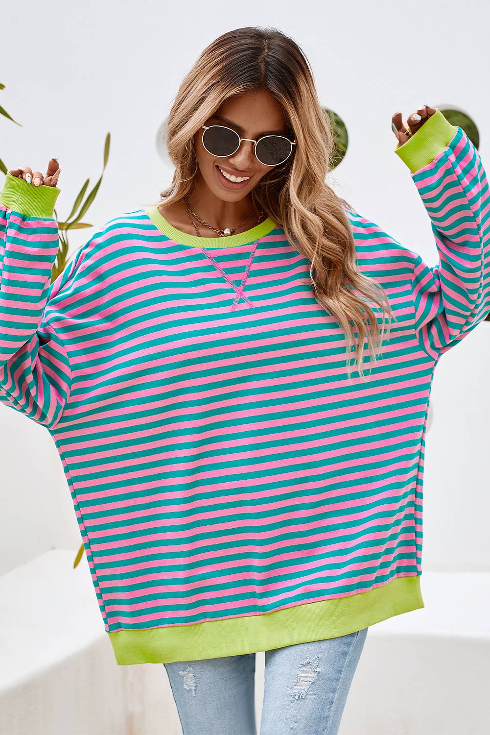This colorful striped top is both stylish and comfortable. This top features a combination of blue, yellow, and green stripes, making it a vibrant and eye-catching piece.