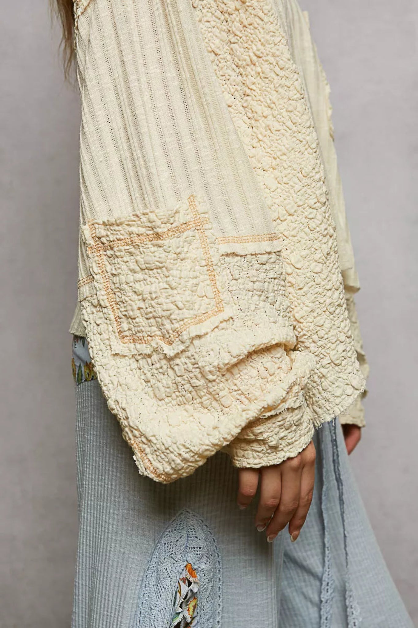 POL women’s cream textured V-neck oversized long sleeve top with raw seam detail and mixed fabric panels