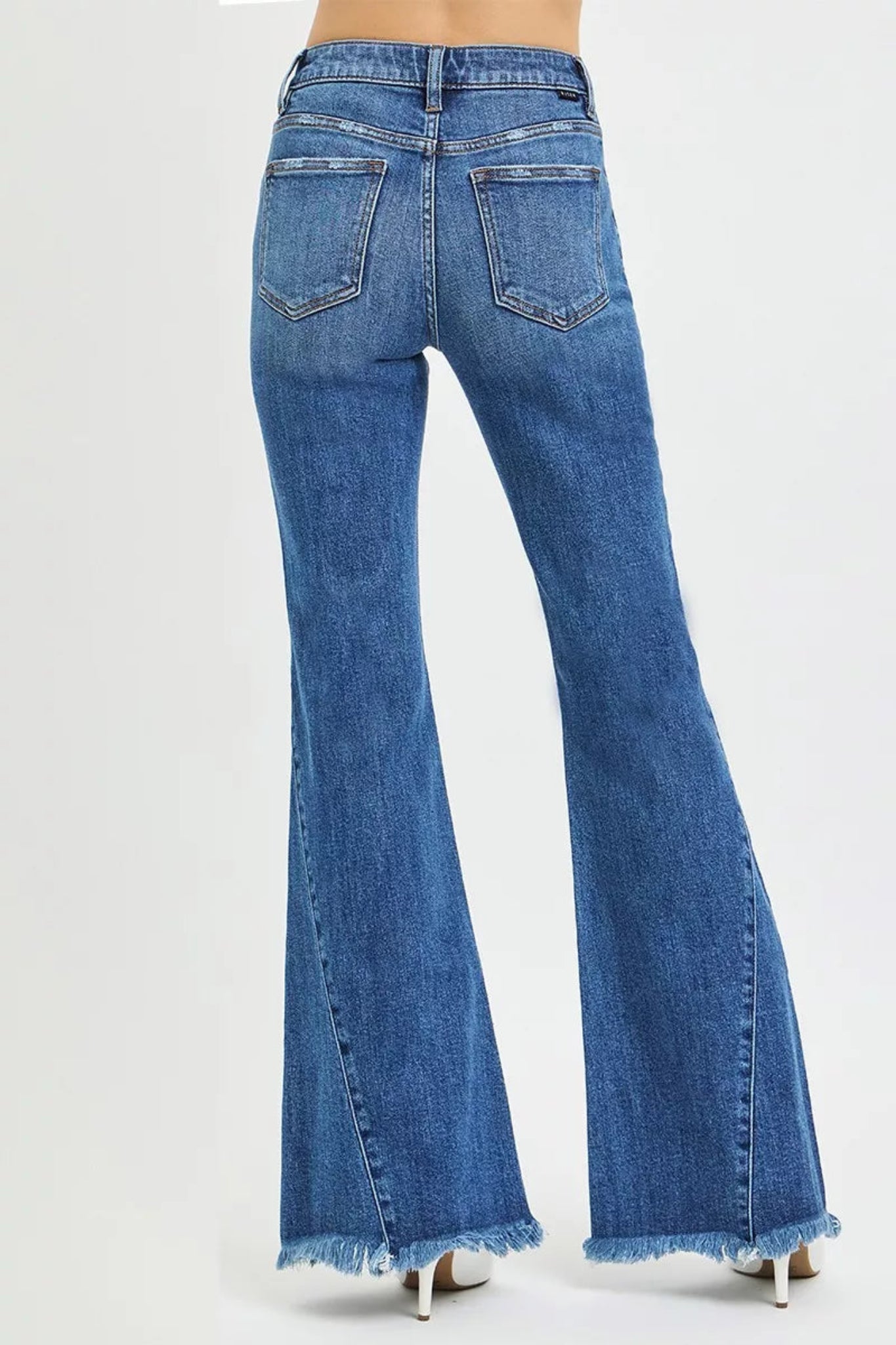 RISEN Mid Rise Flare Side Seam Detailing Jeans in medium wash denim with flattering mid-rise fit, subtle side seam detailing, and trendy flare leg silhouette. Comfortable stretch denim perfect for everyday wear, casual outfits, and boutique fashion styling.