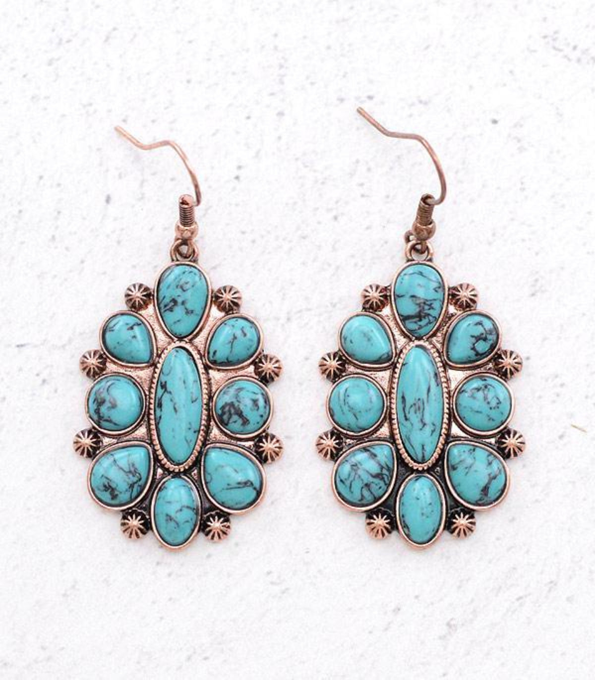 Pair of turquoise-colored western-inspired earrings featuring casting hook backs.