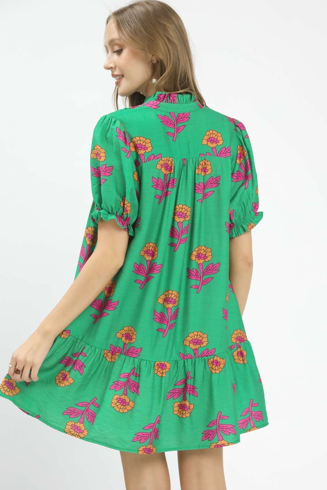 Green floral baby-doll mini dress with pink and orange flowers, smocked yoke, button front detail, and short puff sleeves, flowy and lightweight for spring and summer