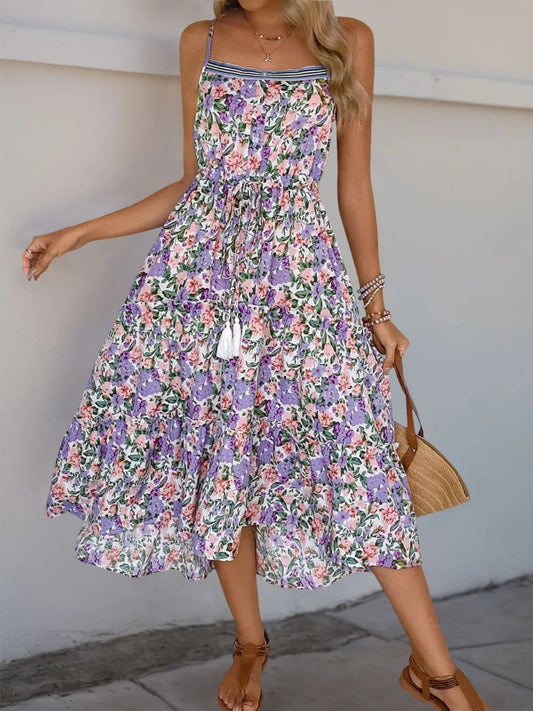 Floral tiered maxi dress with lavender, pink, and green print, adjustable spaghetti straps, drawstring waist, and flowy lightweight fabric for spring and summer