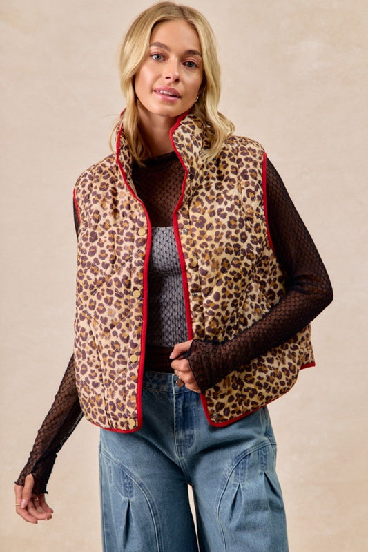 BiBi leopard print quilted vest featuring cozy padded fabric, contrast piping detail, and lightweight sleeveless design perfect for layering. Trendy boutique outerwear with relaxed fit and stylish animal print for casual fall and winter outfits.