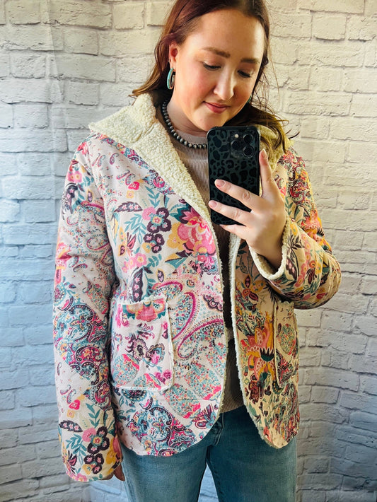 Women's floral fleece jacket featuring a hood, front pockets, soft polyester fabric, and a fitted silhouette.