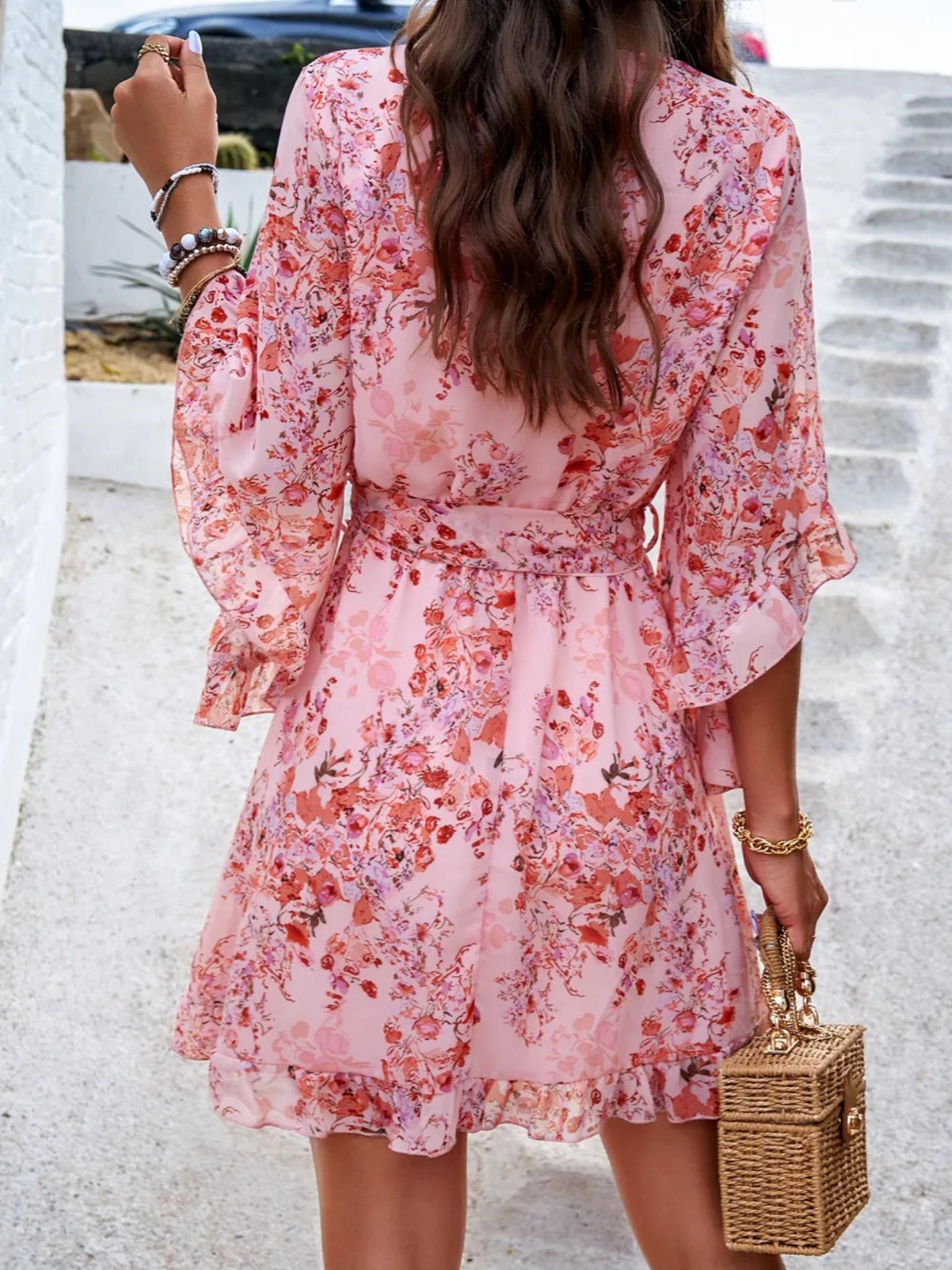 Floral wrap mini dress with ruffle sleeves, tie waist, and V-neckline in multiple color options, lightweight and flowy for spring and summer wear