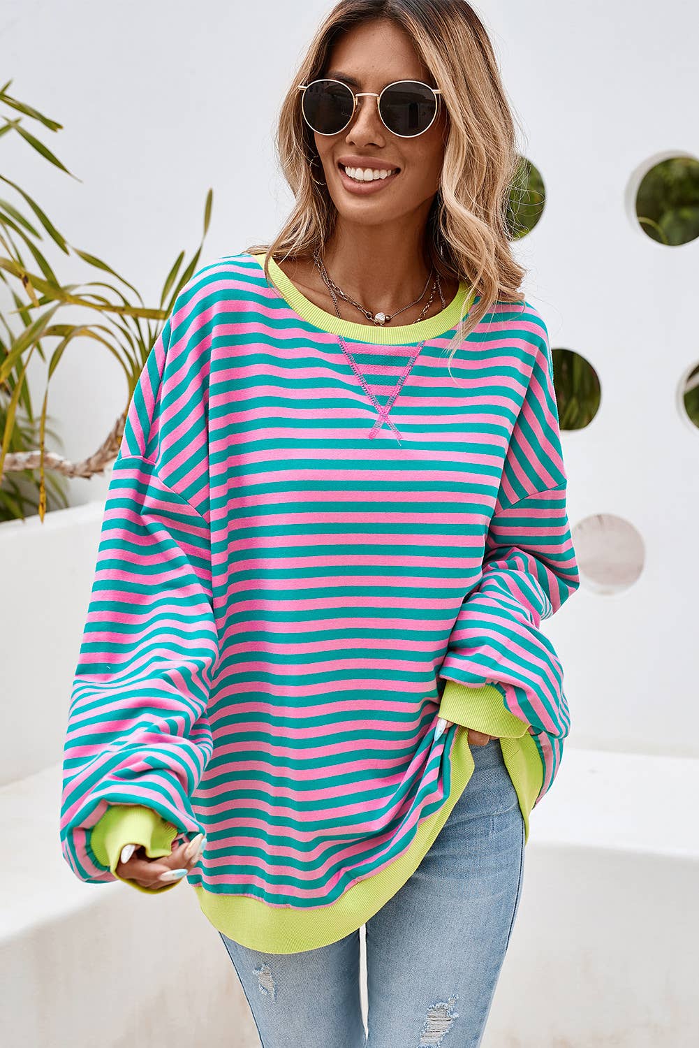 This colorful striped top is both stylish and comfortable. This top features a combination of blue, yellow, and green stripes, making it a vibrant and eye-catching piece.
