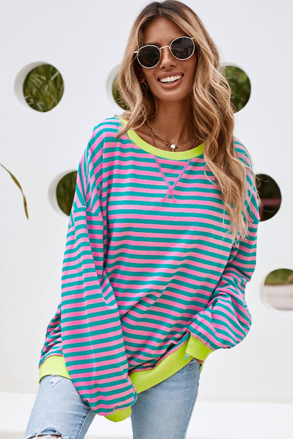 This colorful striped top is both stylish and comfortable. This top features a combination of blue, yellow, and green stripes, making it a vibrant and eye-catching piece.
