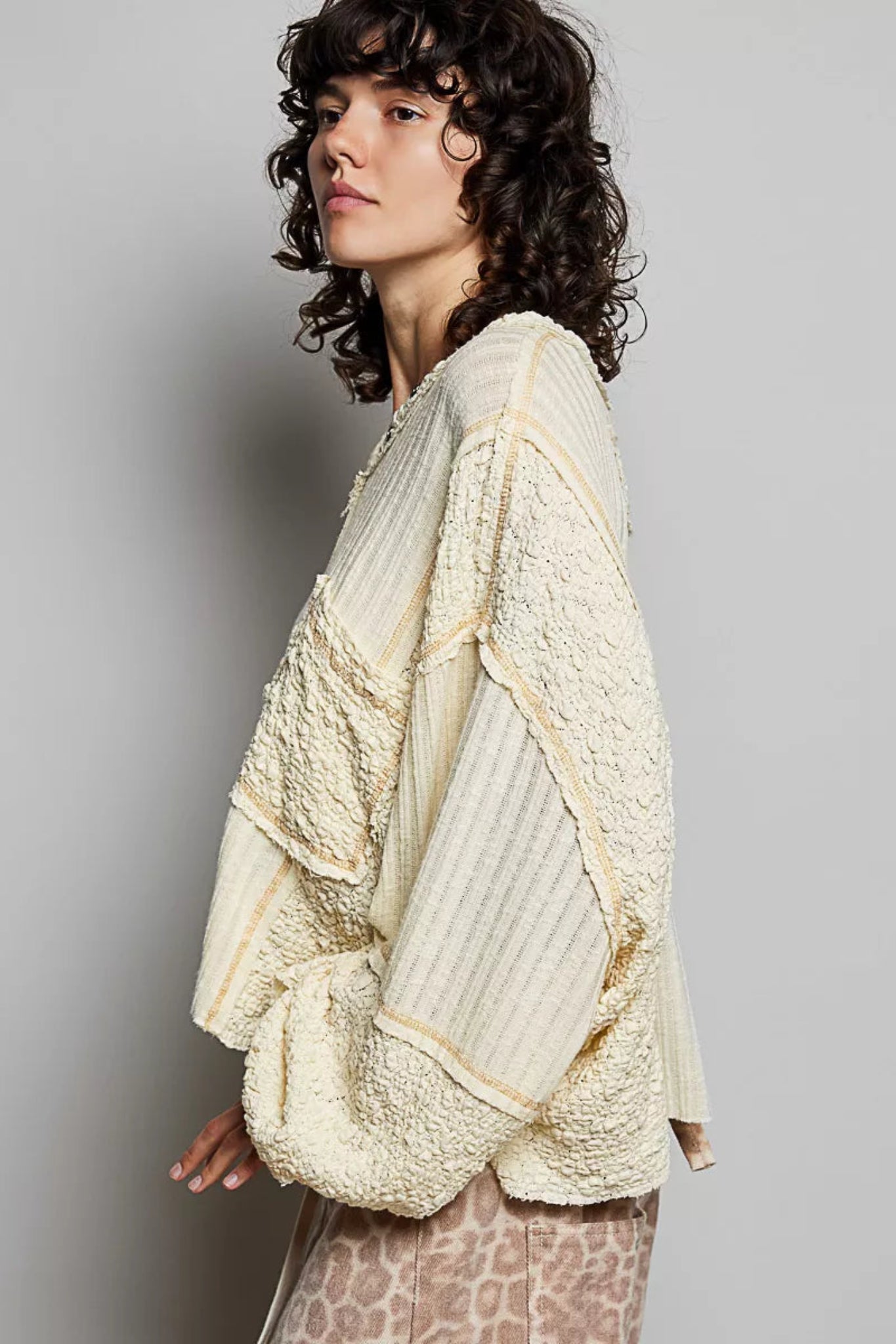 POL women’s cream textured V-neck oversized long sleeve top with raw seam detail and mixed fabric panels