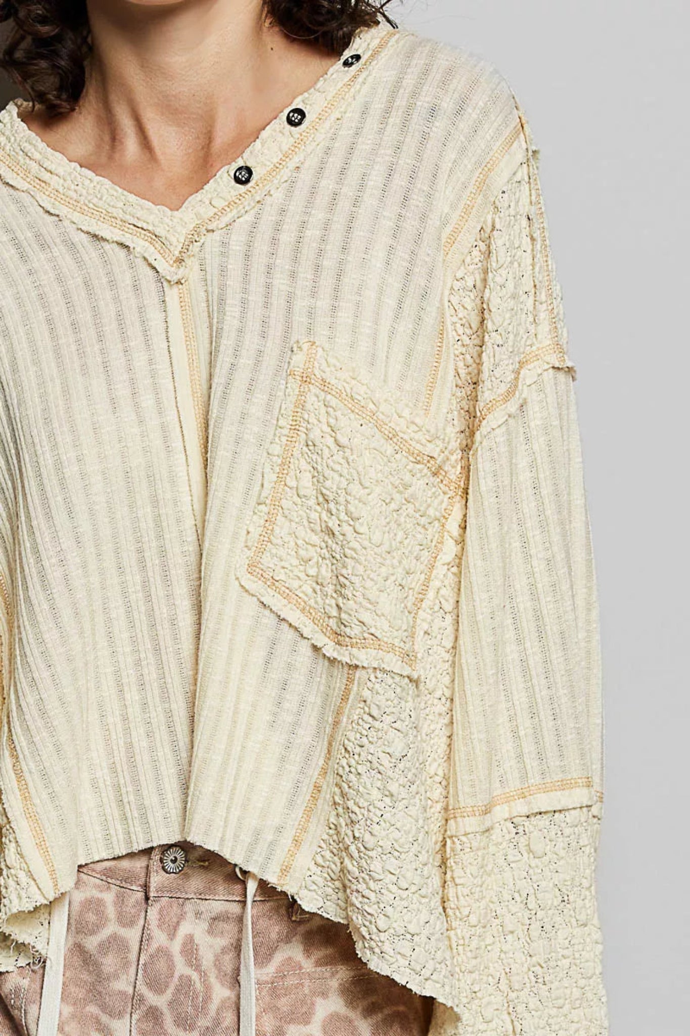 POL women’s cream textured V-neck oversized long sleeve top with raw seam detail and mixed fabric panels