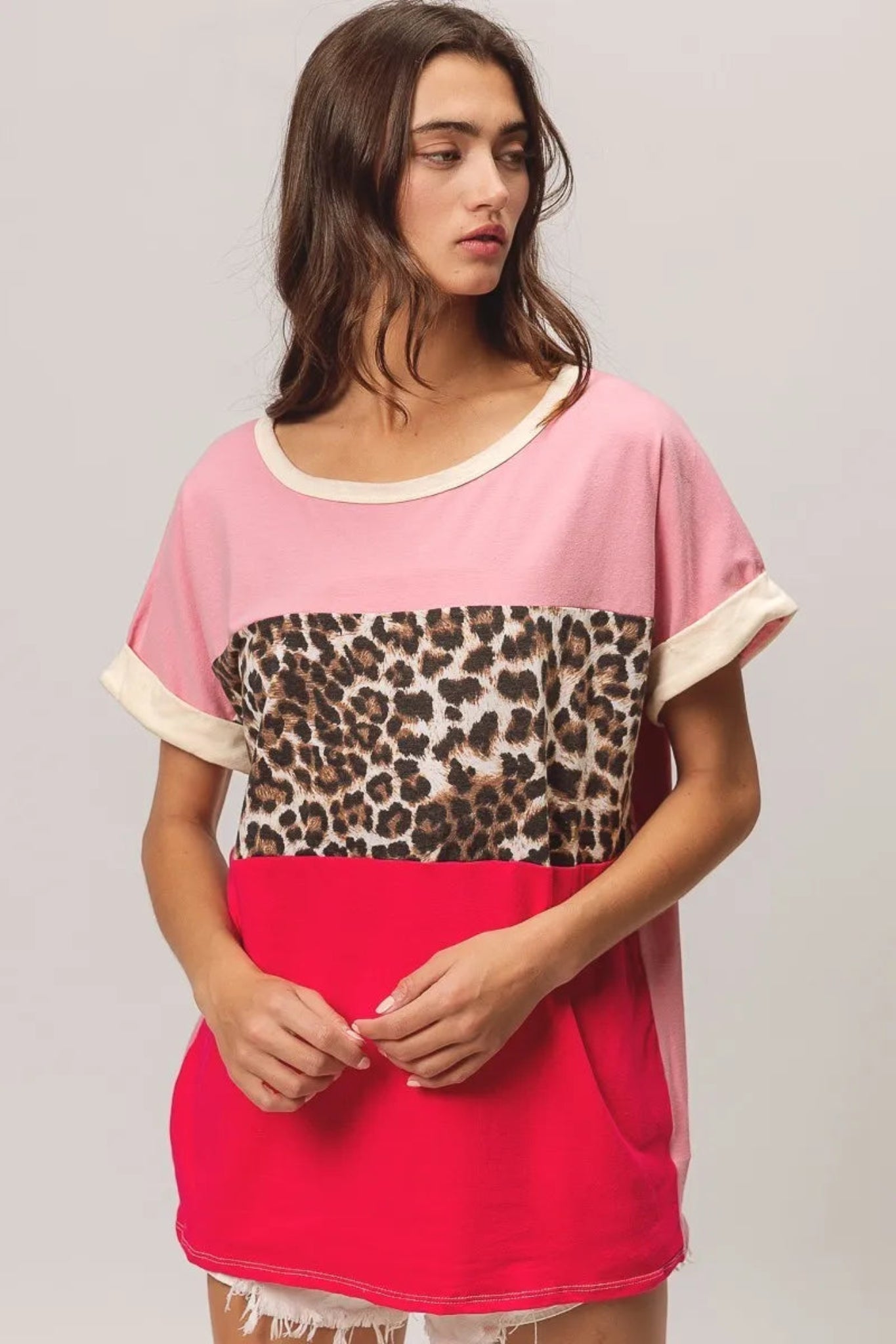 BiBi leopard print color block jersey top with soft knit fabric, contrast color block design, and rolled short sleeves. Casual boutique top with trendy animal print detail and relaxed everyday fit perfect for jeans or shorts.