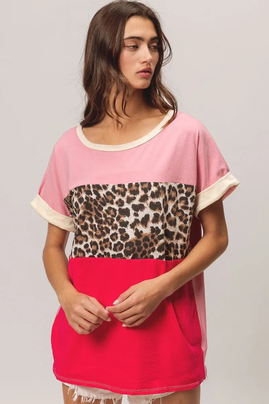 BiBi leopard print color block jersey top with soft knit fabric, contrast color block design, and rolled short sleeves. Casual boutique top with trendy animal print detail and relaxed everyday fit perfect for jeans or shorts.