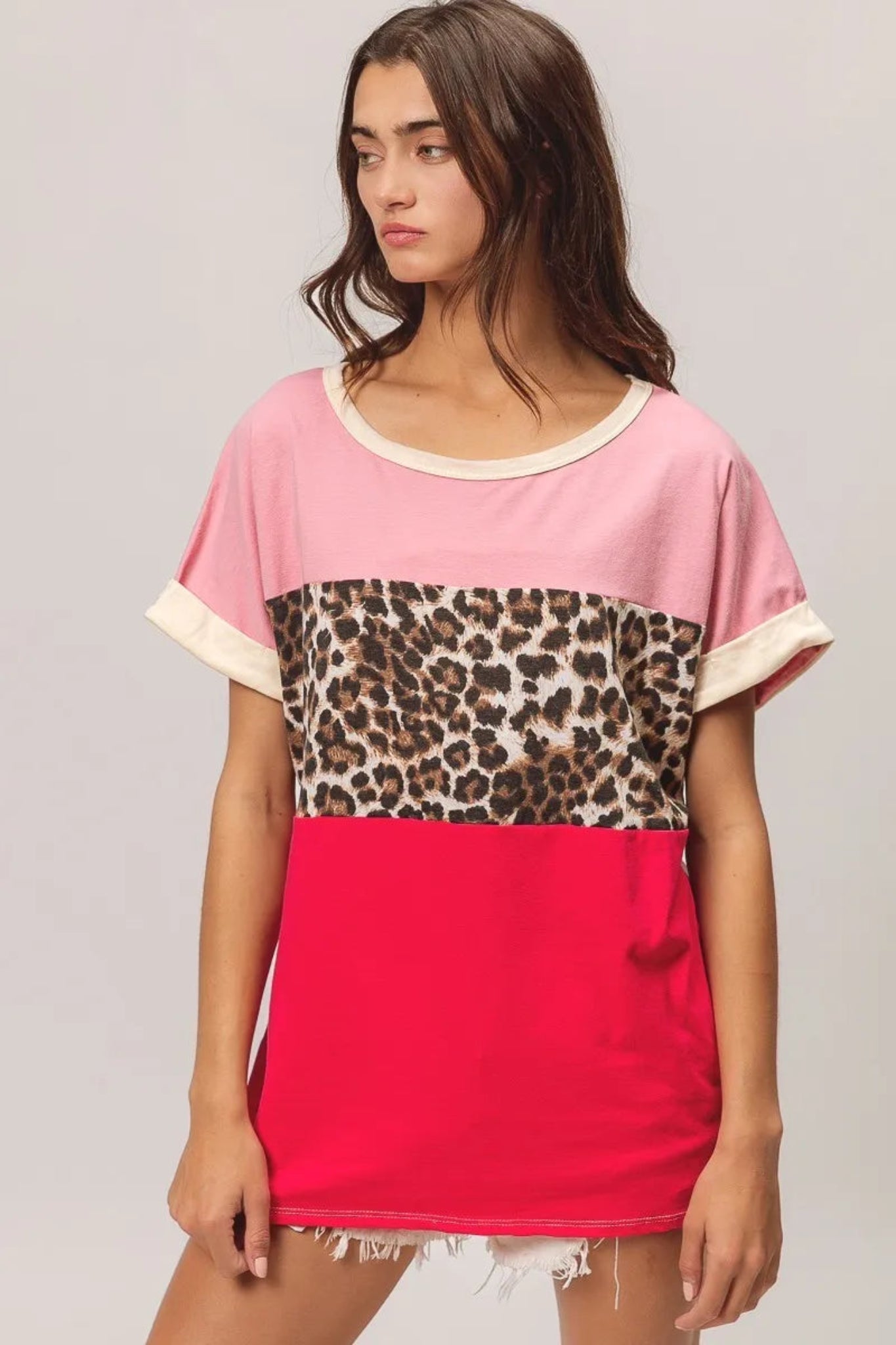 BiBi leopard print color block jersey top with soft knit fabric, contrast color block design, and rolled short sleeves. Casual boutique top with trendy animal print detail and relaxed everyday fit perfect for jeans or shorts.