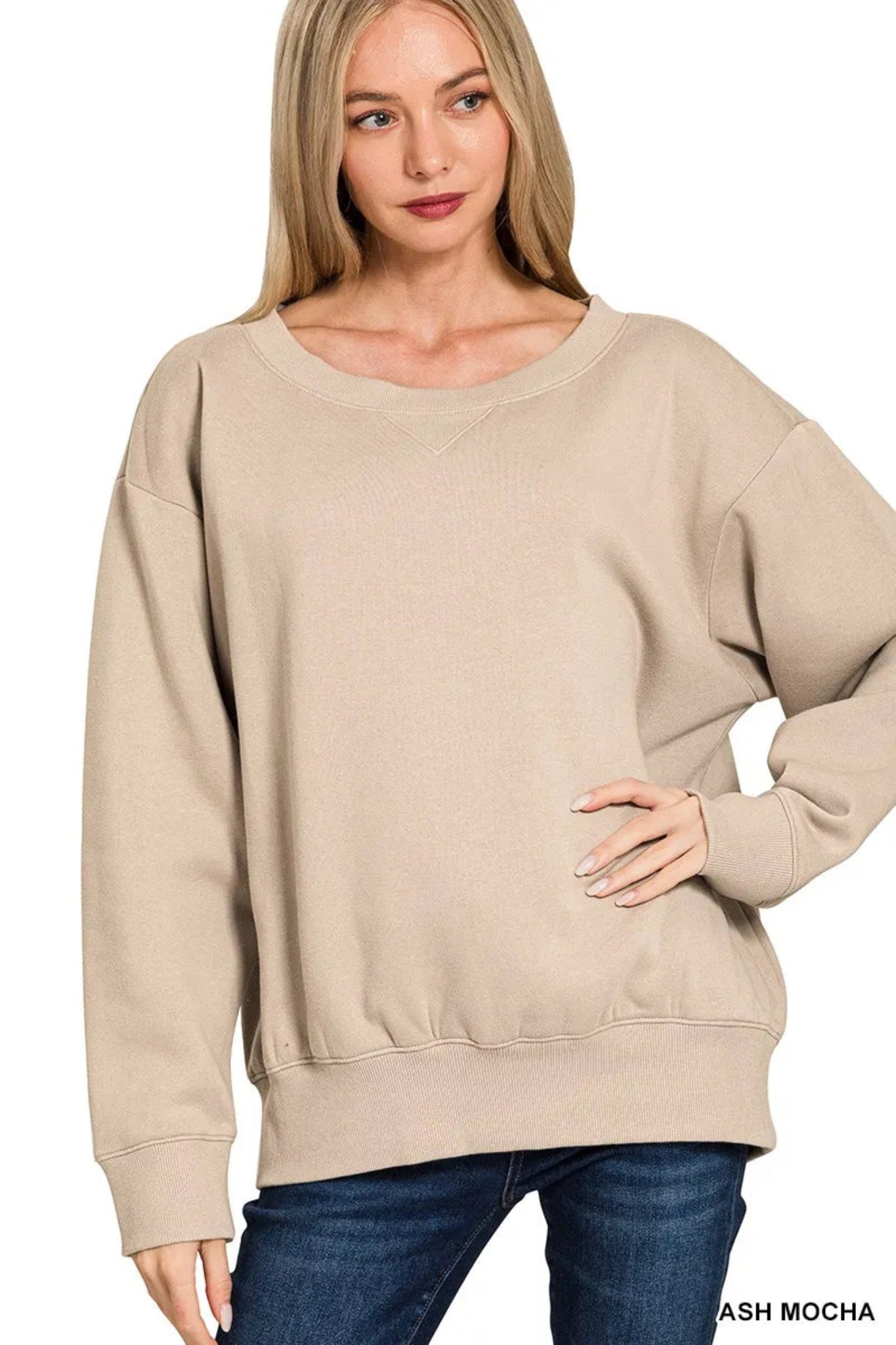 Woman wearing a mocha long sleeve boat neck sweatshirt with relaxed fit, ribbed cuffs and hem, casual everyday pullover top.