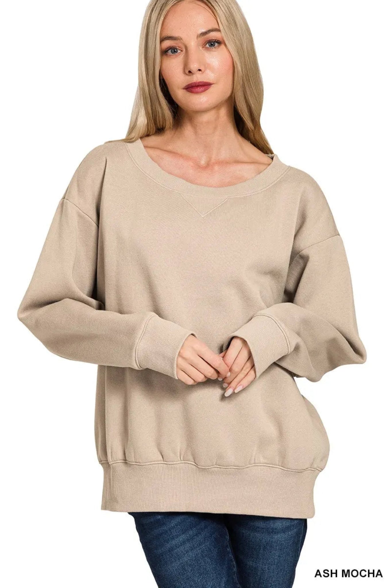 Woman wearing a mocha long sleeve boat neck sweatshirt with relaxed fit, ribbed cuffs and hem, casual everyday pullover top.
