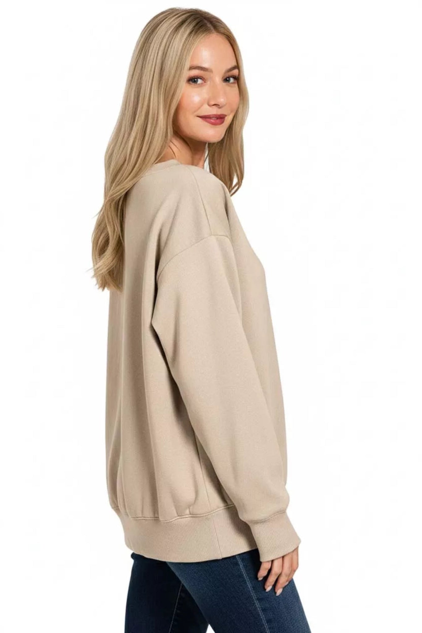 Woman wearing a mocha  long sleeve boat neck sweatshirt with relaxed fit, ribbed cuffs and hem, casual everyday pullover top.
