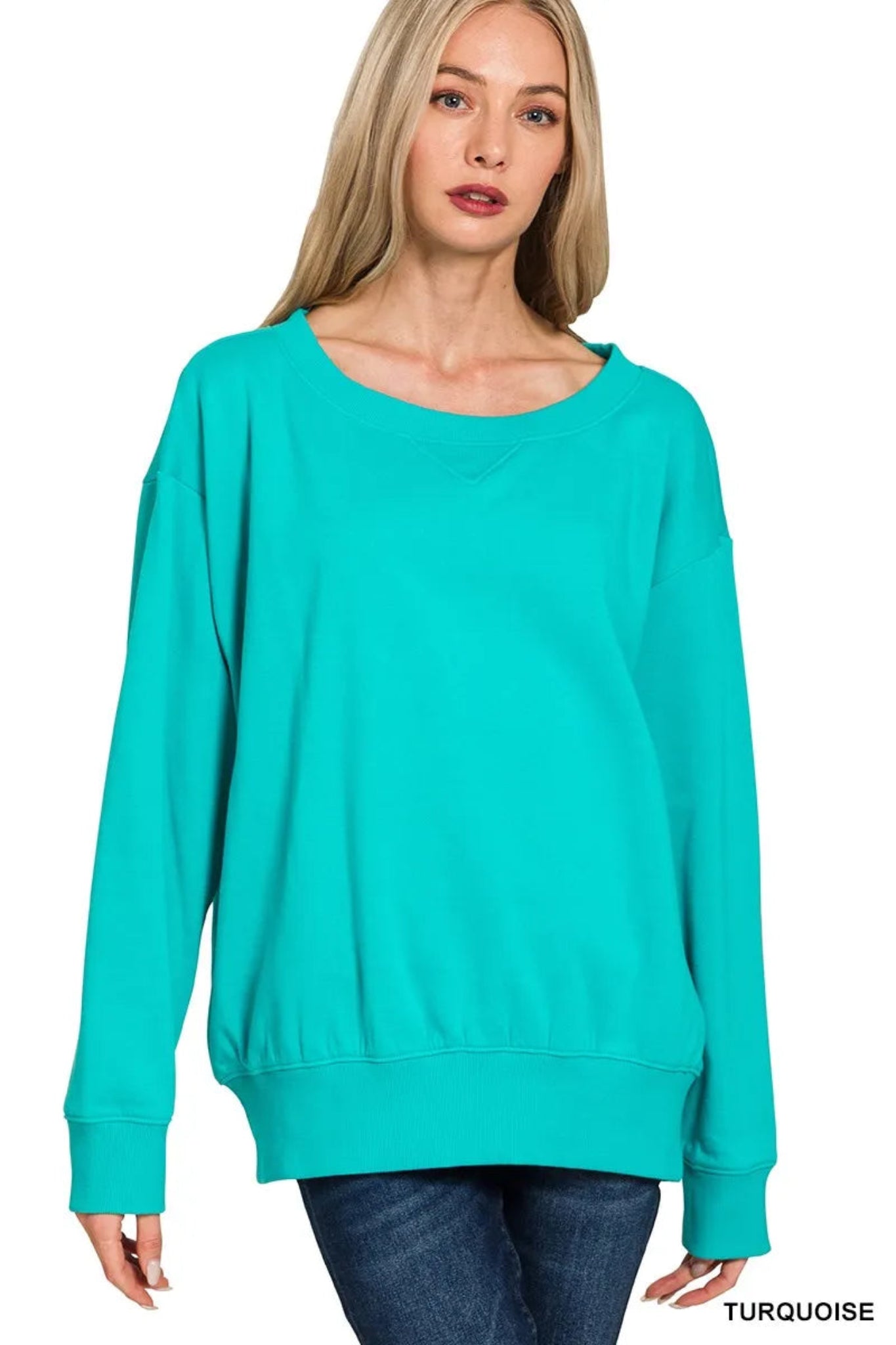 Woman wearing a turquoise long sleeve boat neck sweatshirt with relaxed fit, ribbed cuffs and hem, casual everyday pullover top.