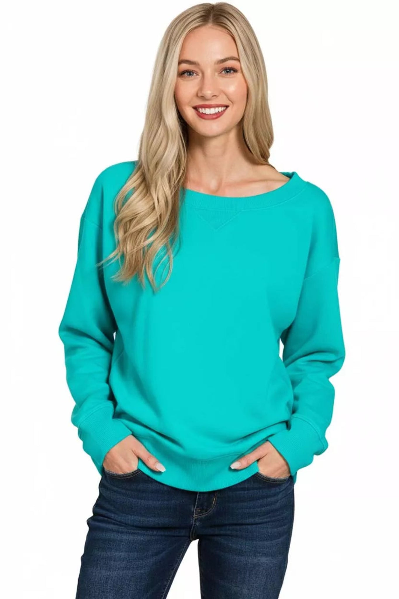 Woman wearing a turquoise long sleeve boat neck sweatshirt with relaxed fit, ribbed cuffs and hem, casual everyday pullover top.