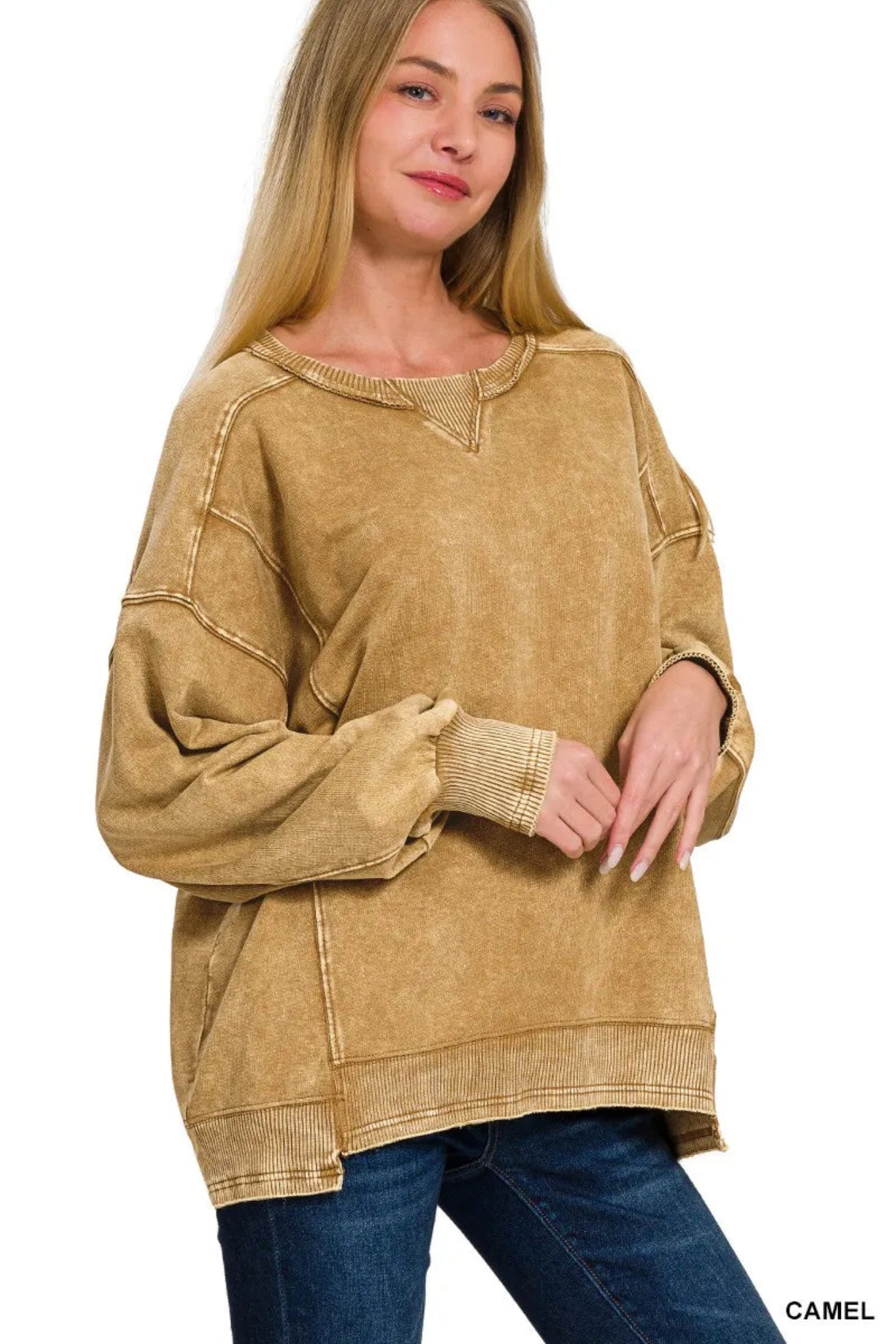 Woman wearing a camel washed long sleeve pullover sweatshirt with relaxed fit, ribbed cuffs and hem, and casual everyday style.
