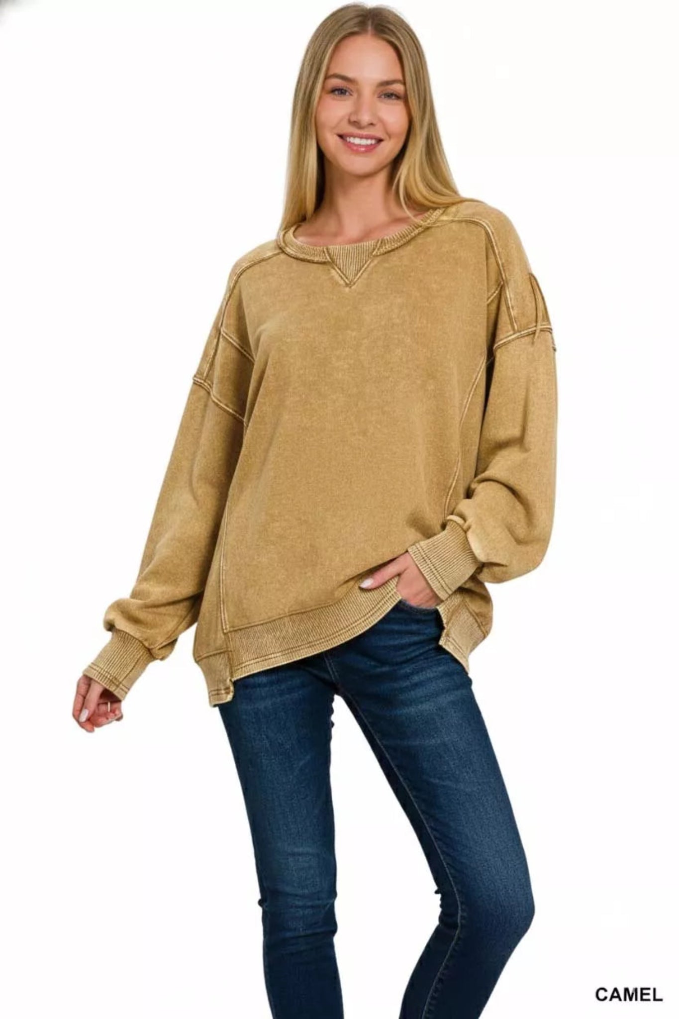 Woman wearing a camel washed long sleeve pullover sweatshirt with relaxed fit, ribbed cuffs and hem, and casual everyday style.