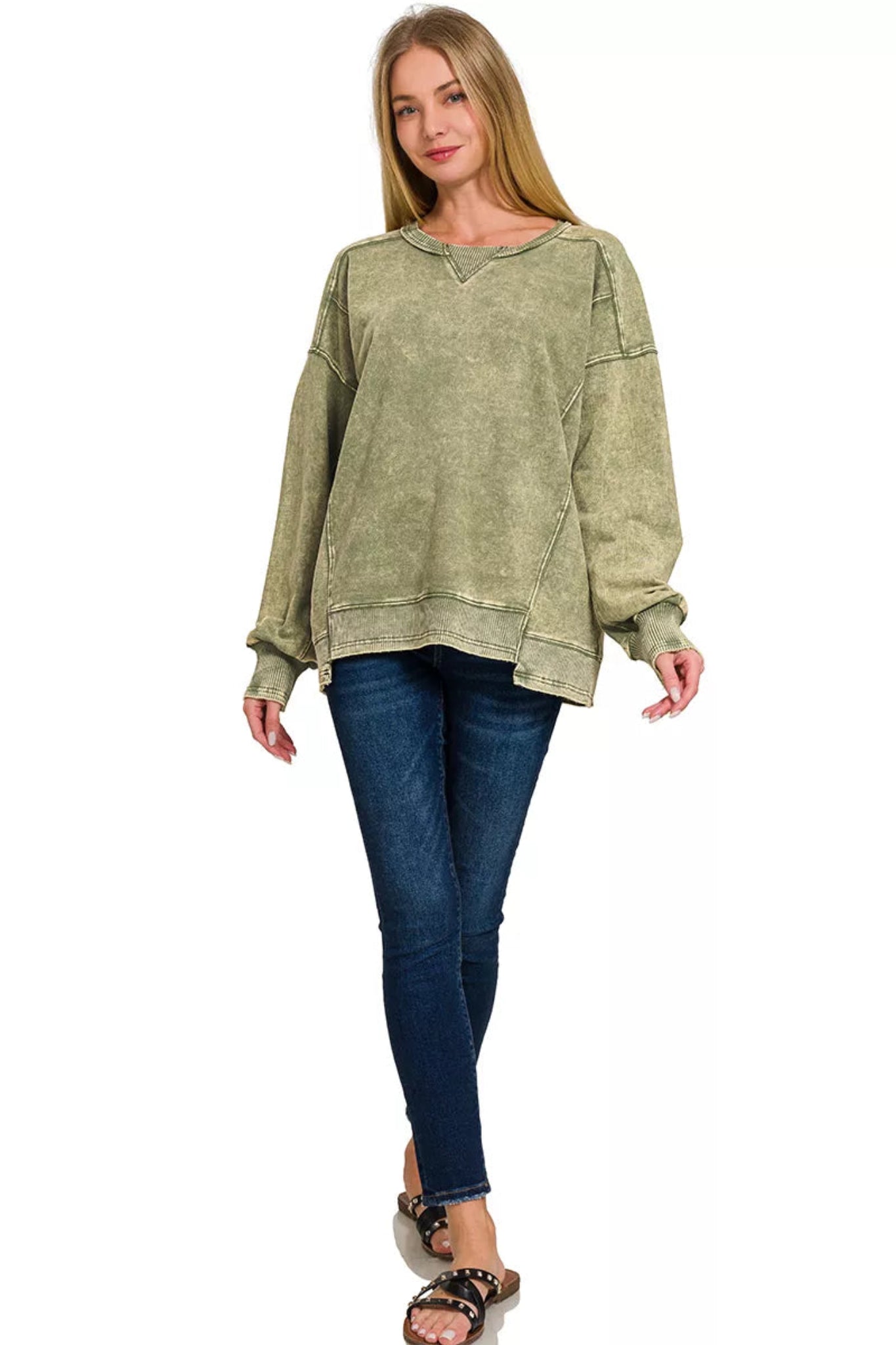 Woman wearing a olive washed long sleeve pullover sweatshirt with relaxed fit, ribbed cuffs and hem, and casual everyday style.