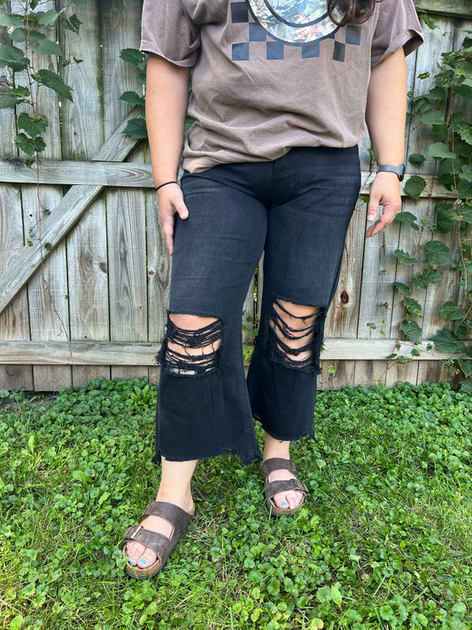 black distressed denim cropped with frayed edges 